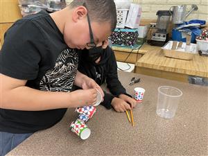two students working together to create an anemometer