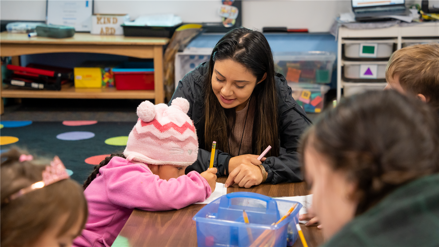 Teacher teaches students their letters. Teacher teaches students their letters.
